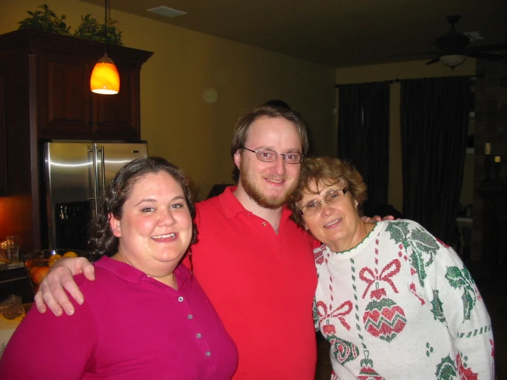 an older man poses with two younger women