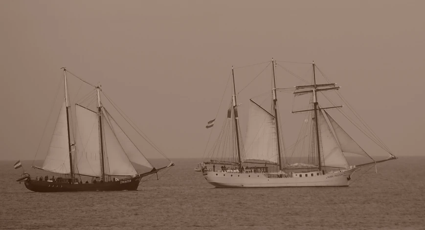 two sailboats sailing on the open water