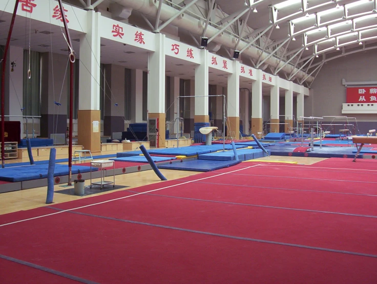 an indoor gymnasium full of blue and yellow mats