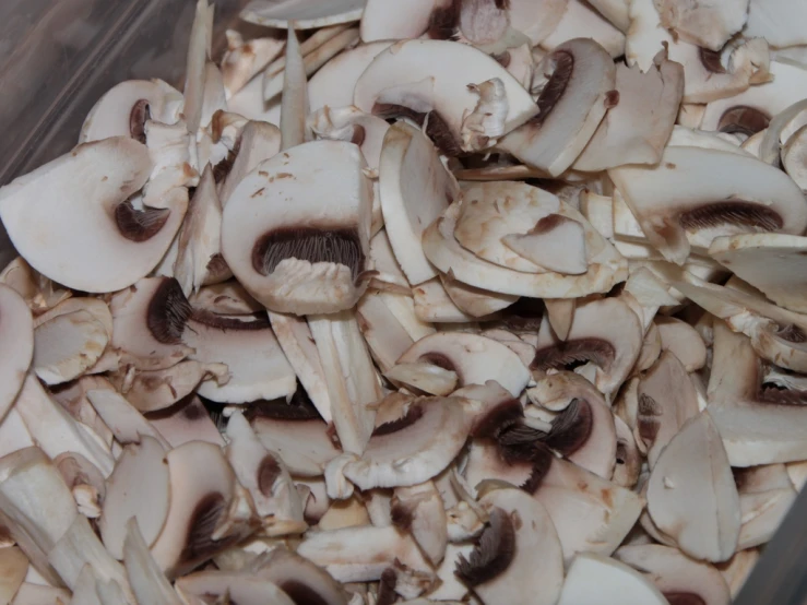 mushrooms are piled together in a plastic container