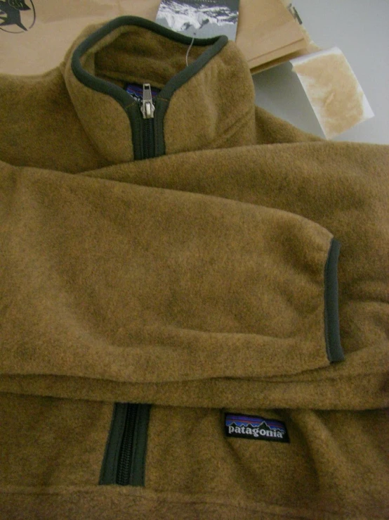 a large brown jacket on top of a white table