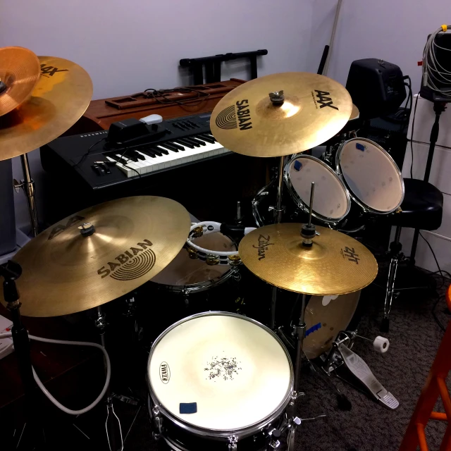 an electronic musical system and several drum heads in a room