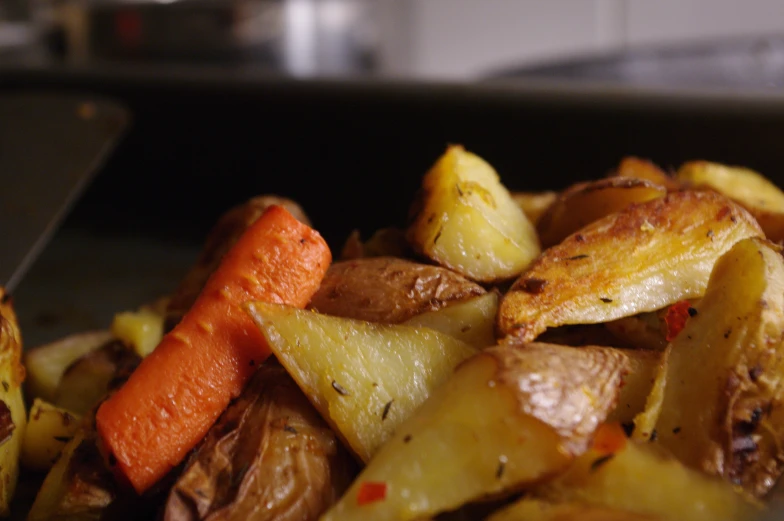 a close up of some cooked potatoes and carrots