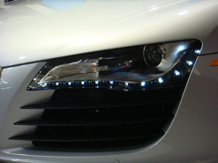 the front lights of a white car