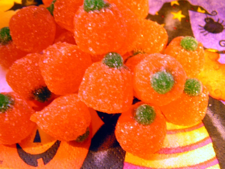 there are several orange jello candies with sprinkles on them