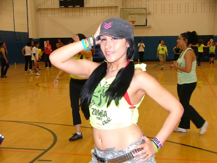 a female wearing a grey hat and sunglasses posing