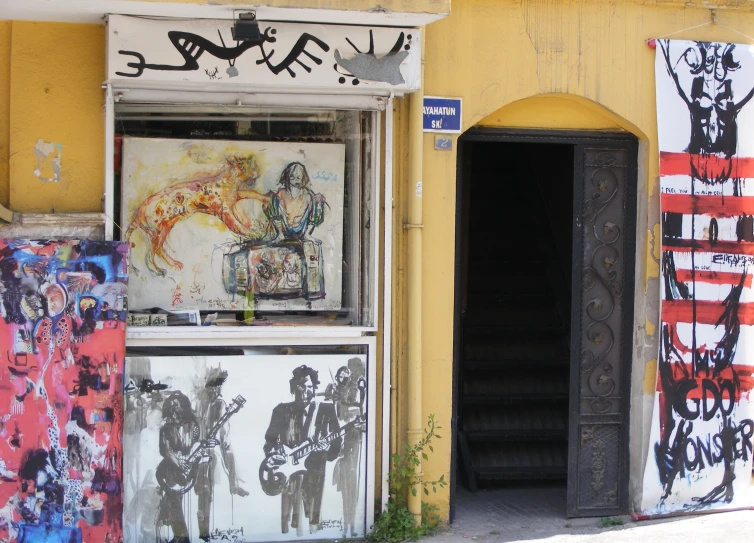 a doorway to an abandoned building with art work