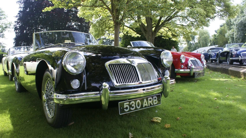 a vintage british car parked by the side of the road