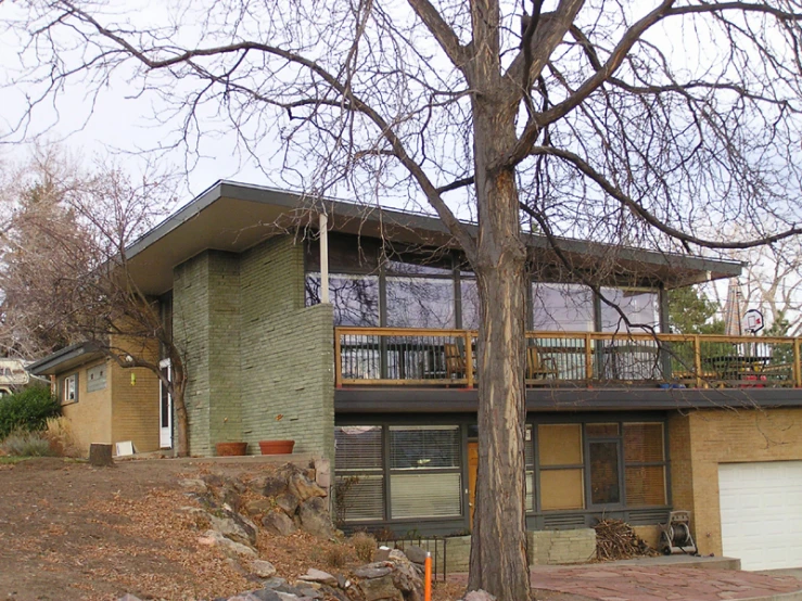 the outside of the building shows the front lawn and deck