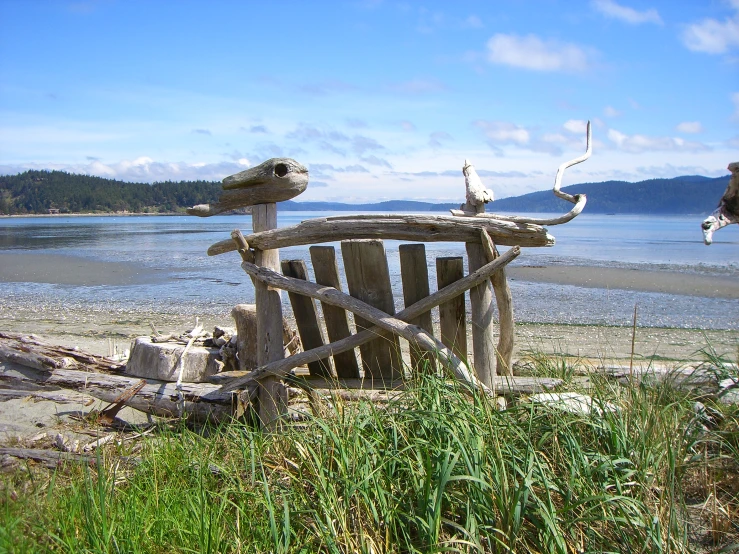 this old chair sits out on the beach