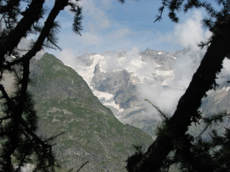 a mountain view in the distance, looking at a cloud and fog