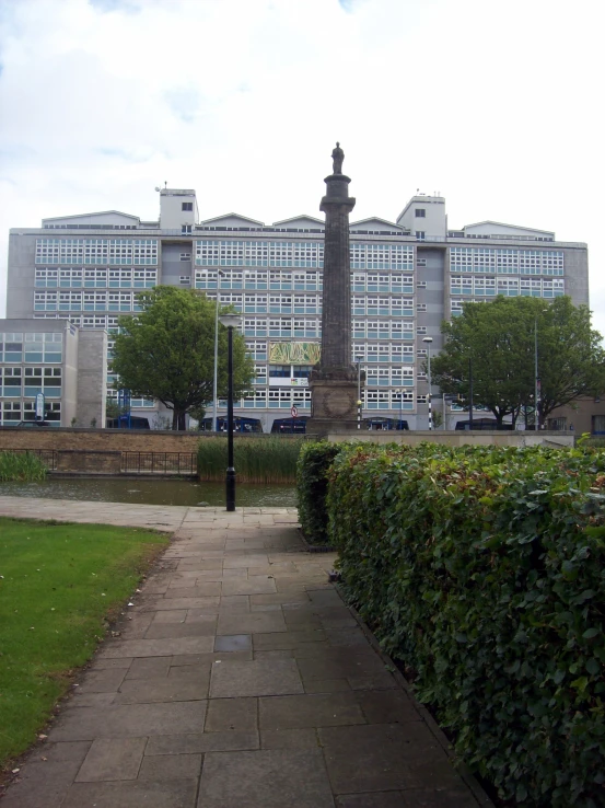 a long walkway leads through the park towards the large buildings