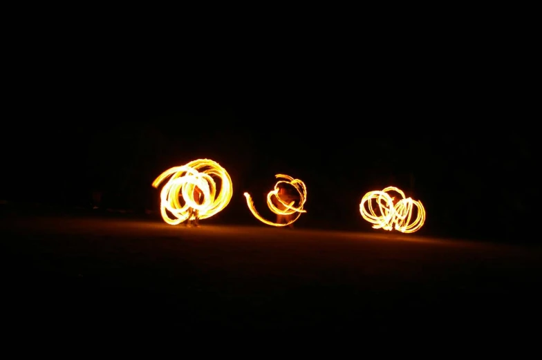 four orange lights shine on the ground, making them appear like circles