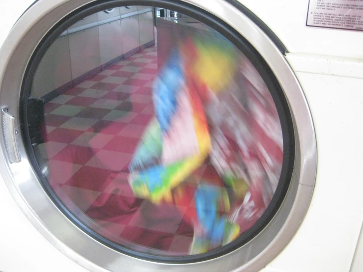 a colorful painting in the front of a washing machine