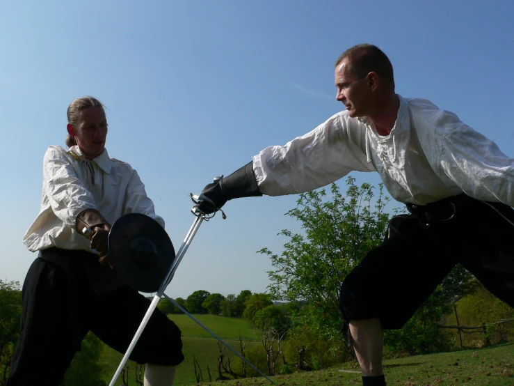 a man in a period costume holds on to a whip during the daytime