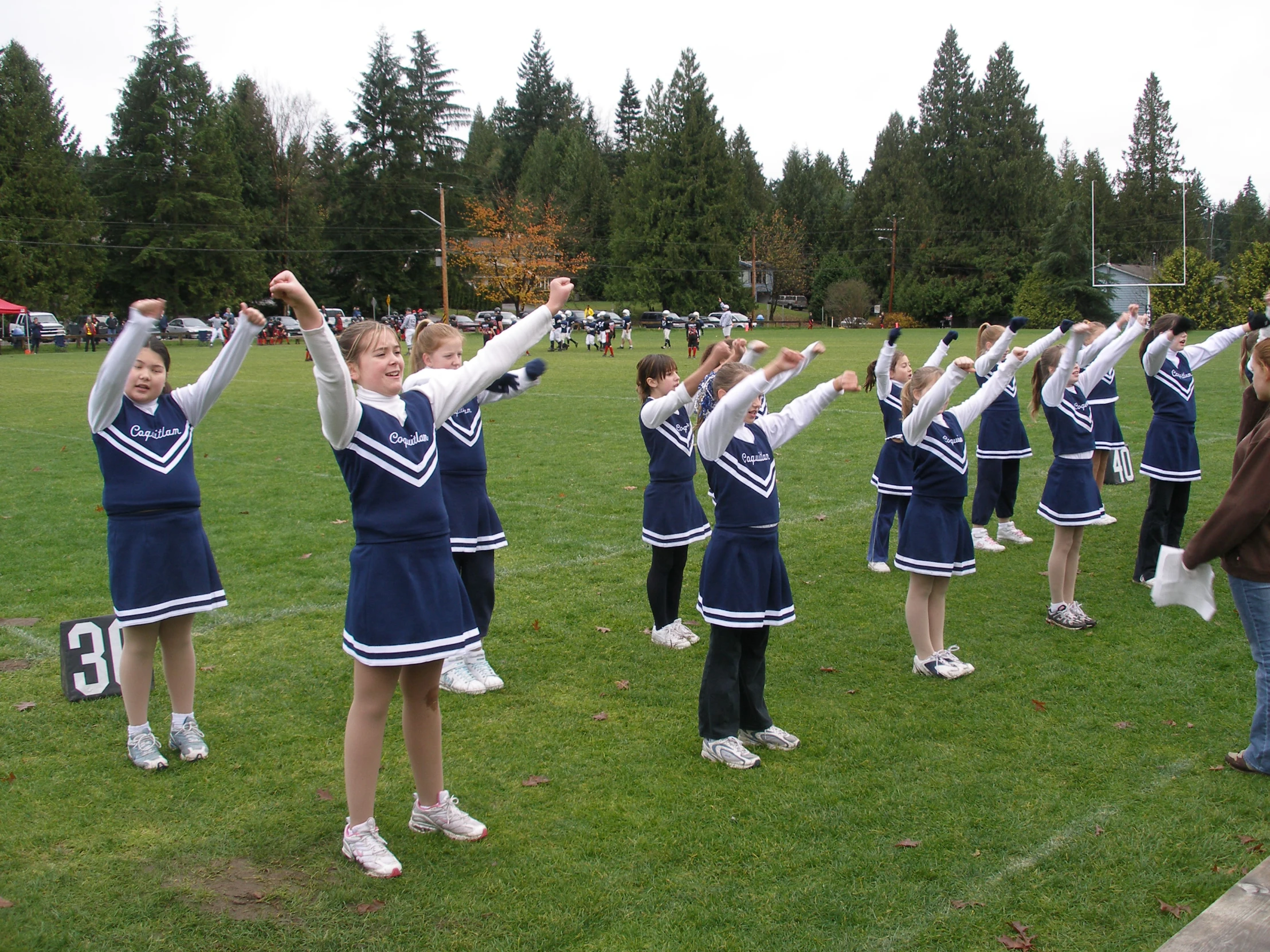 s in cheer costumes are performing a marching trick