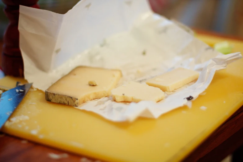 the cheese has been cut into cubes on the  board