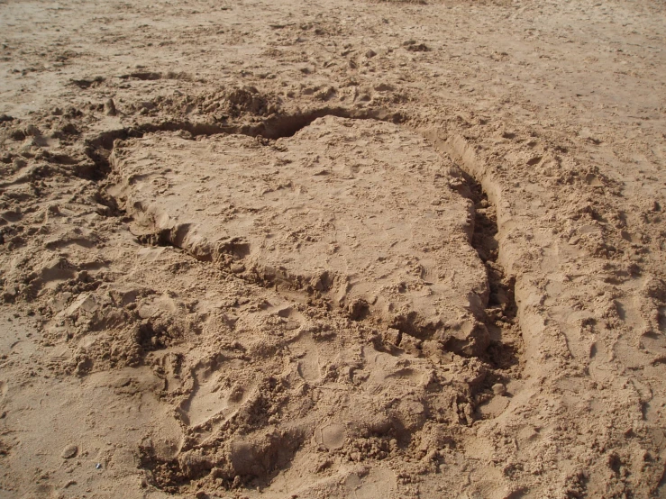 a heart drawn in the sand on the beach