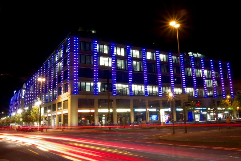 a very tall blue building with some lights