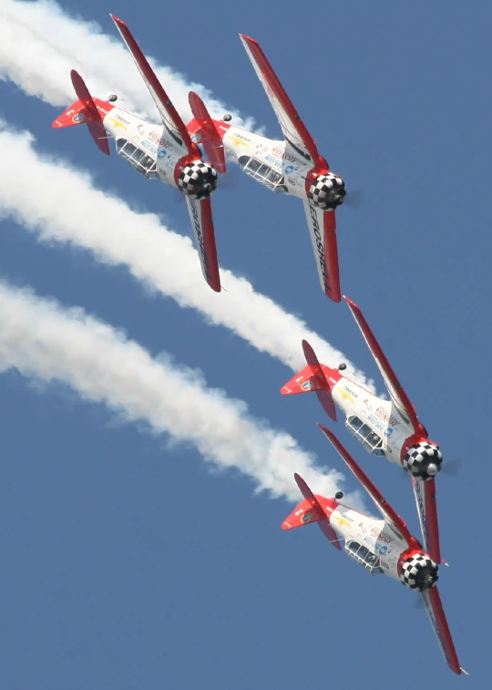 a formation of four airplanes flying in the air