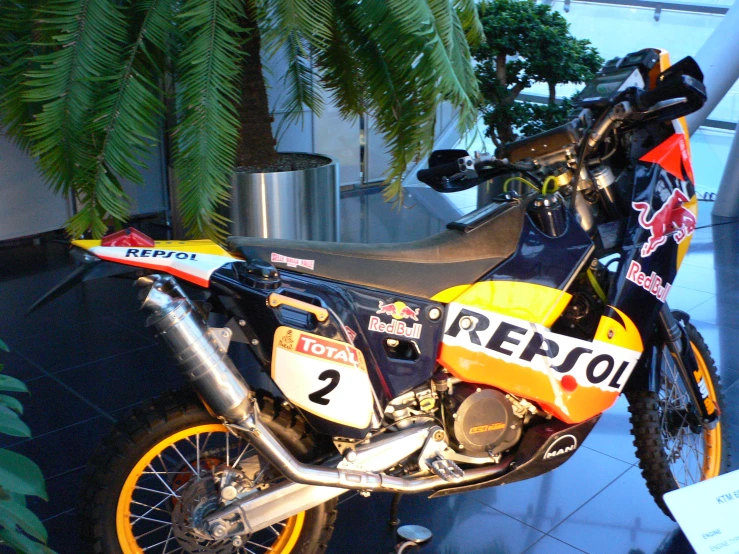 a motorbike sitting in front of a window on display