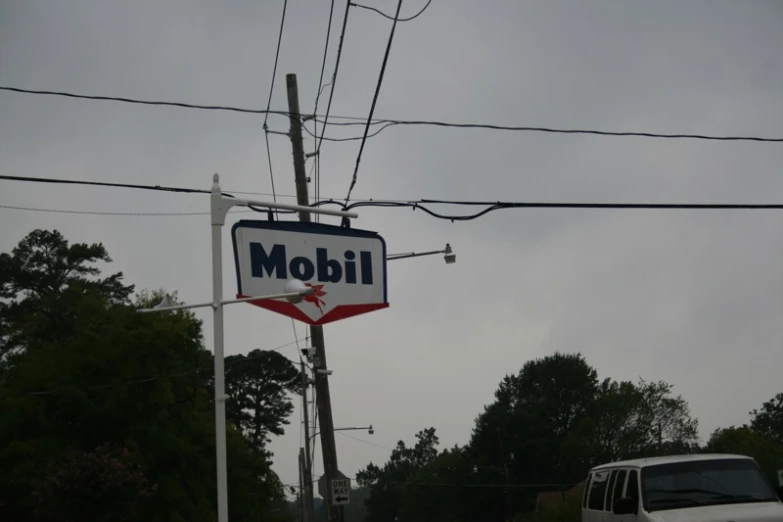 an old motel sign is next to a truck