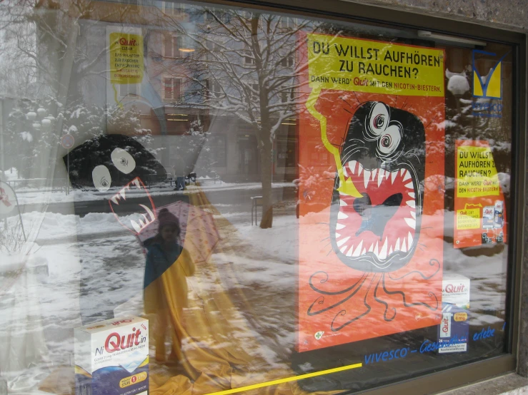 a window has been decorated with posters and fake dolls