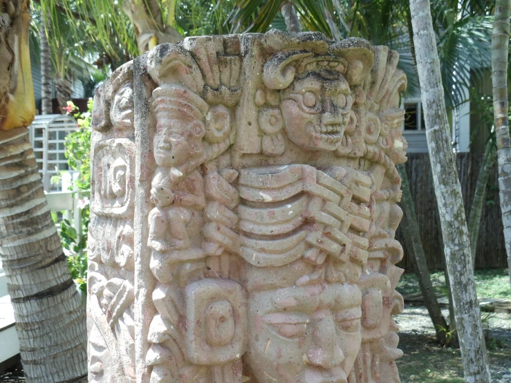 a concrete carving is shown in a garden