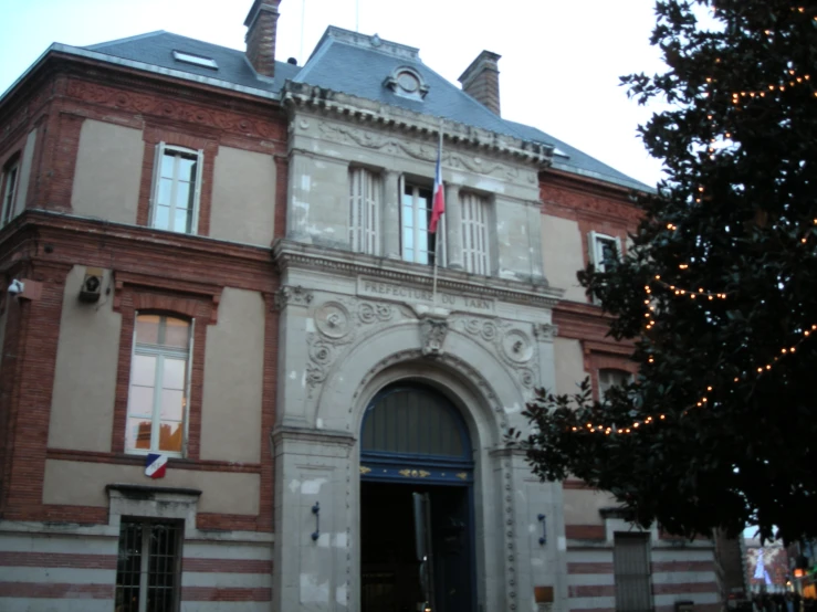 a red brick building with a flag on top