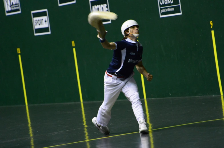 a man with a white helmet and white pants, holding a baseball bat