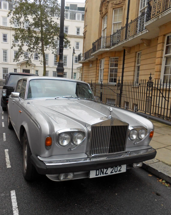 silver car parked on the side of a city street