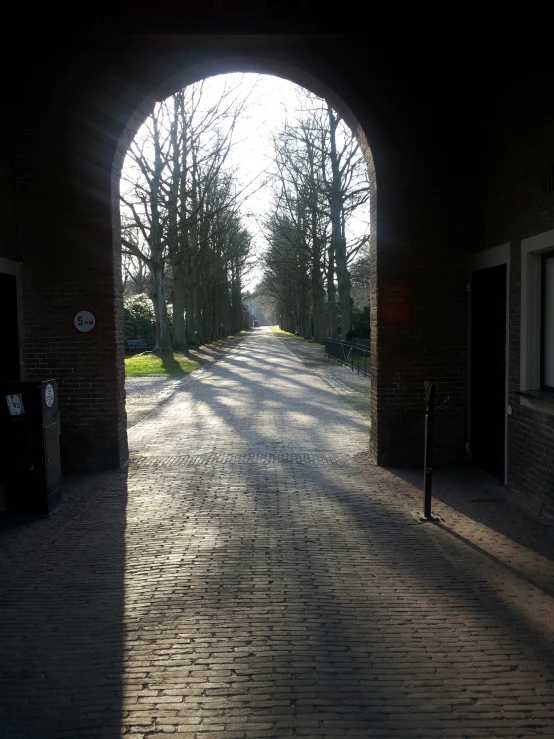 an arched brick walkway is shown through a doorway