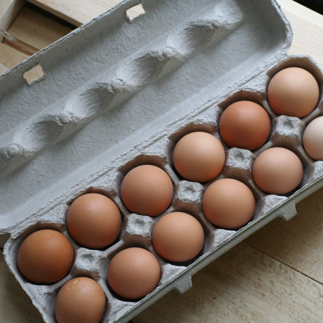 an egg tray with a dozen of eggs