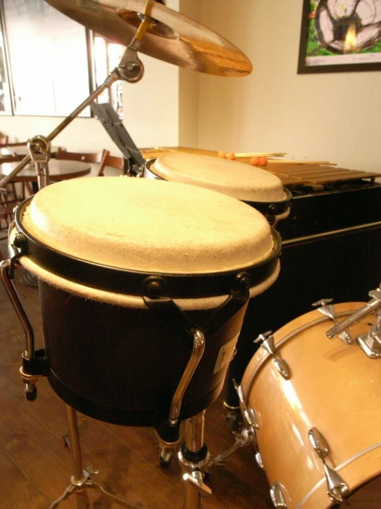 drum and cymbals lined up in the middle of a room