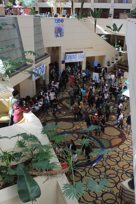 people gather in a lobby near an indoor building