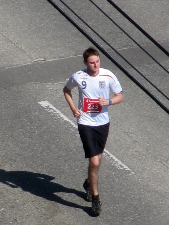 a man running down the street near a traffic light