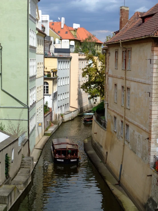 an old boat in a small canal between two buildings