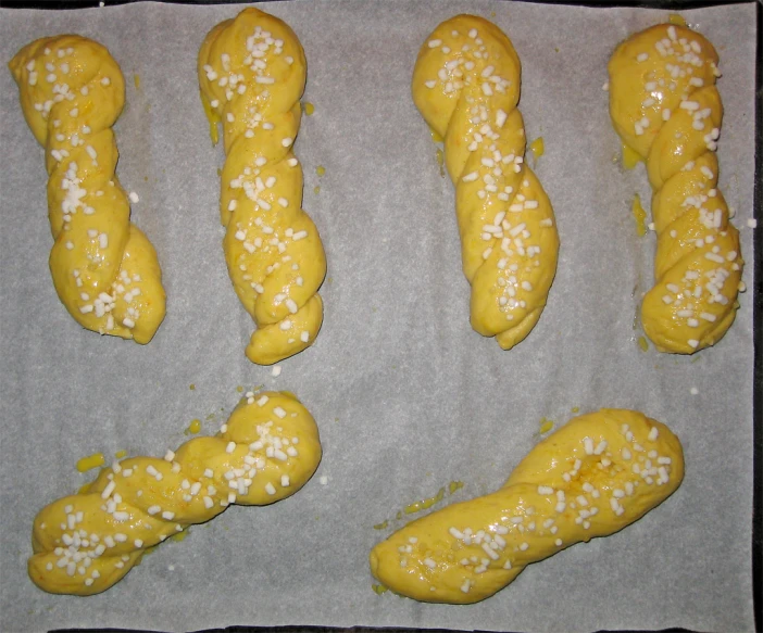 several pretzels sitting on top of a pan covered in icing