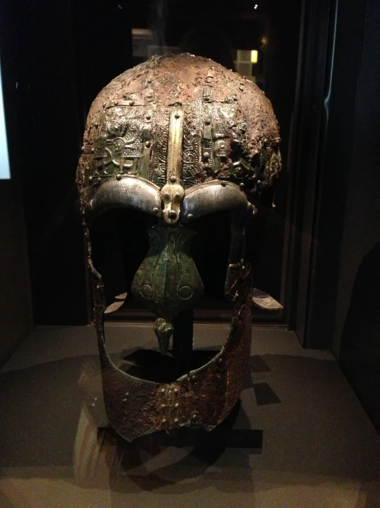 an antique helmet with ss parts on display in glass case