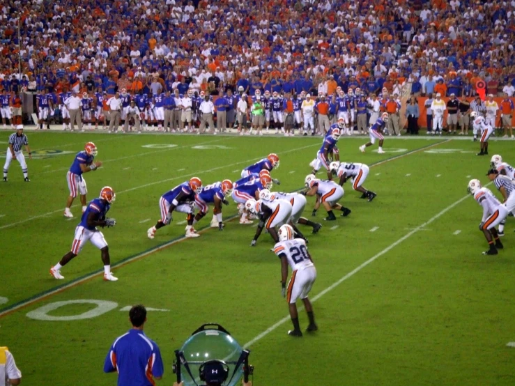 football players are on the field playing in front of a crowd