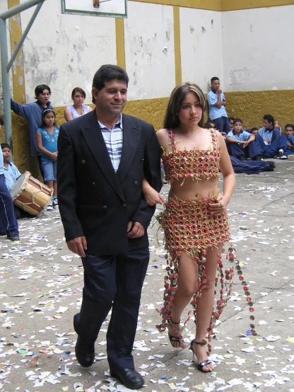 a man and a women who are wearing beaded clothing