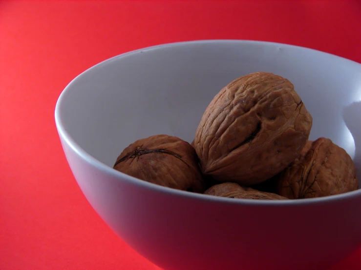 there is a bowl filled with nuts on the table