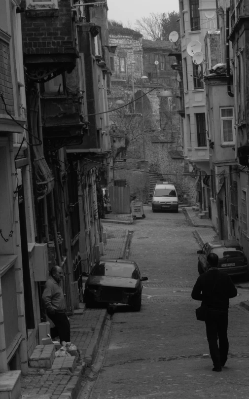 two men are walking down the street in this old picture