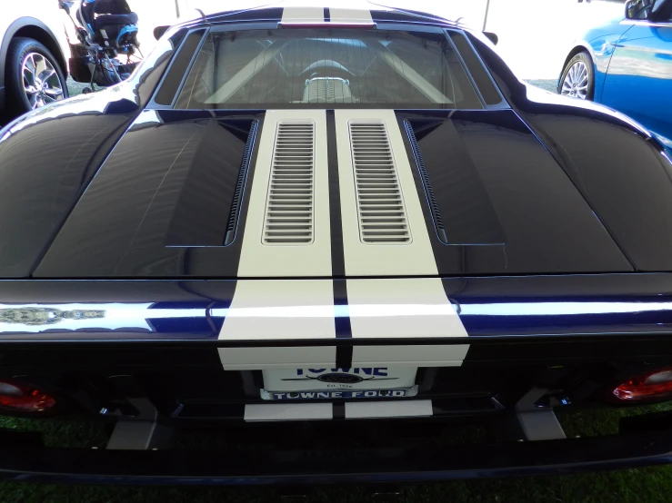 a blue and white car sitting in the grass