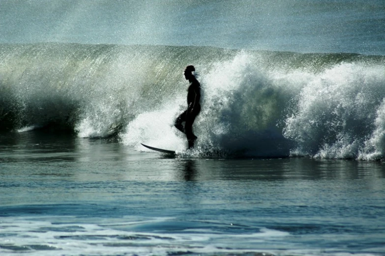 a surfer in the middle of riding a huge wave