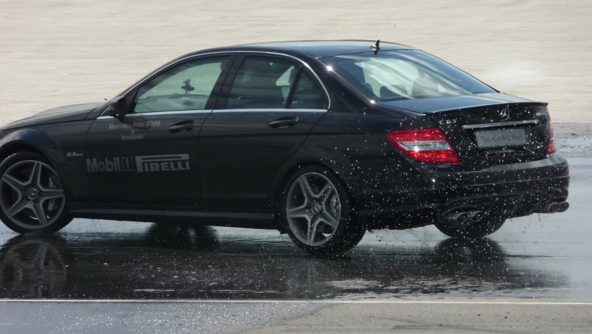 a mercedes benz in the rain with its trunk open