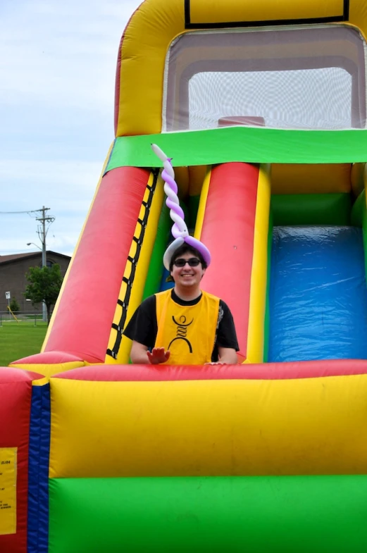 this boy has a yellow shirt and hat on