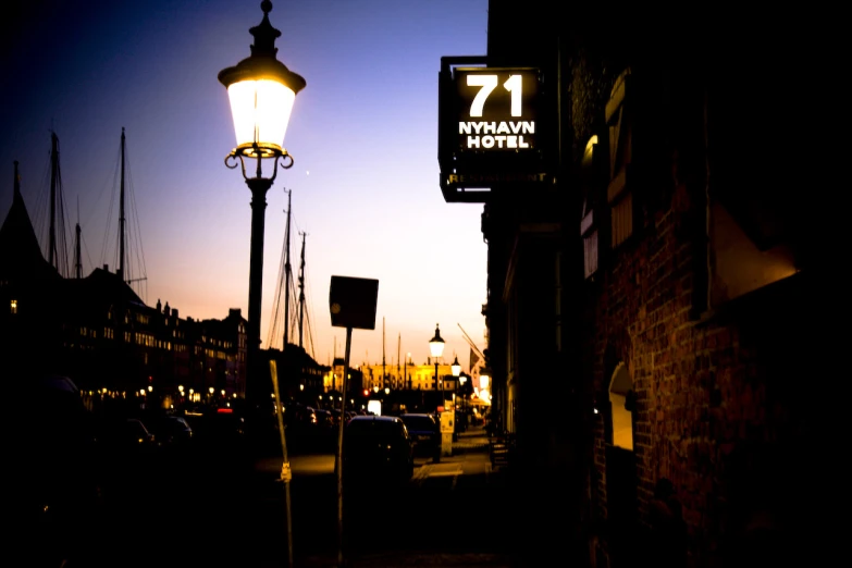 a building with a clock tower lit by a street light