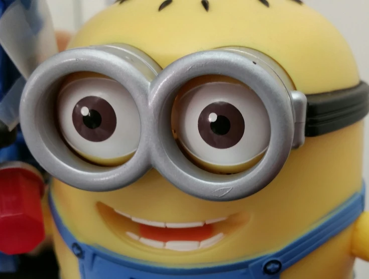 a closeup of a toy minions minion with large, round eyes