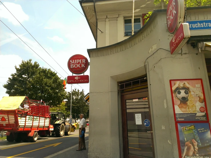 there is a man standing outside of the store